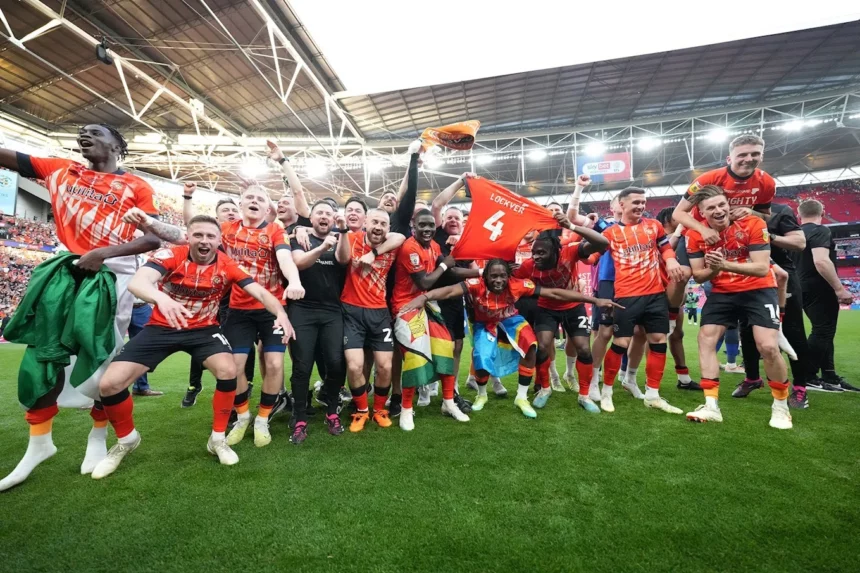 Luton Town FC players celebrating their promotion to the Premier League.