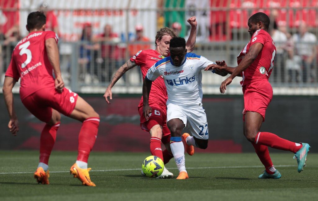 Lameck Banda is challenged by AC Monza's Nicolo Rovella and Marlon during the Serie A match between AC Monza and US Lecce at Stadio Brianteo on May 28, 2023 in Monza, Italy. (Photo by Emilio Andreoli/Getty Images)