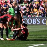 Christine Sinclair reacts on the ground after missing a penalty as Nigeria's goalkeeper Chiamaka Nnadozie (R) celebrates her save.(Photo by WILLIAM WEST/AFP via Getty Images)