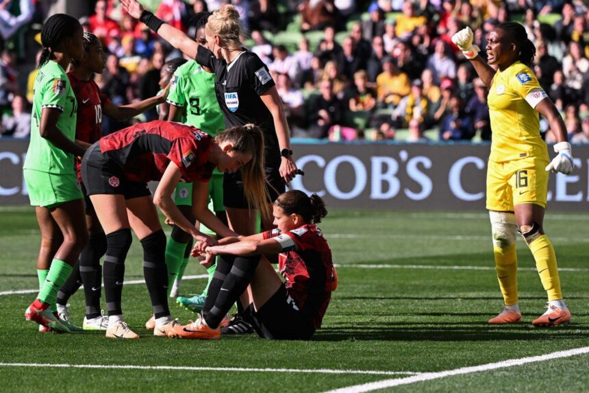 Christine Sinclair reacts on the ground after missing a penalty as Nigeria's goalkeeper Chiamaka Nnadozie (R) celebrates her save.(Photo by WILLIAM WEST/AFP via Getty Images)