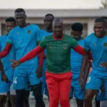 Malawi National Football team caretaker Coach Patrick Mabedi sharing a light momemt with his players. (Picture via FB/Football Association of Malawi)