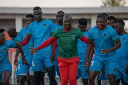 Malawi National Football team caretaker Coach Patrick Mabedi sharing a light momemt with his players. (Picture via FB/Football Association of Malawi)