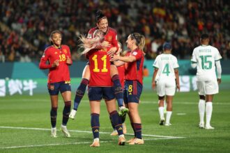 Jennifer Hermoso (top) celebrates with her Spainsh teammates after scoring her team's second goal. (Photo by Phil Walter/Getty Images)