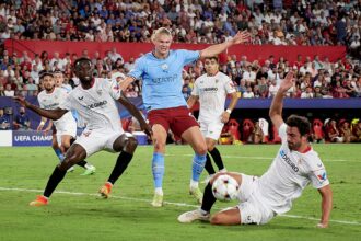 Erling Haaland competes for the ball with Tanguy-Austin Nianzou Kouassi and Thomas Delaney during the UEFA Champions League group G match between Sevilla FC and Manchester City at Estadio Ramon Sanchez Pizjuan. (Photo by Juanjo Ubeda/Quality Sport Images/Getty Images)