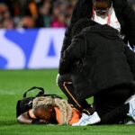 Lushomo Mweemba lies down injured during the Australia and New Zealand 2023 Women's World Cup Group C football match between Zambia and Japan at Waikato Stadium in Hamilton on July 22, 2023. (Photo by Saeed KHAN / AFP)