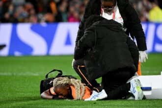 Lushomo Mweemba lies down injured during the Australia and New Zealand 2023 Women's World Cup Group C football match between Zambia and Japan at Waikato Stadium in Hamilton on July 22, 2023. (Photo by Saeed KHAN / AFP)