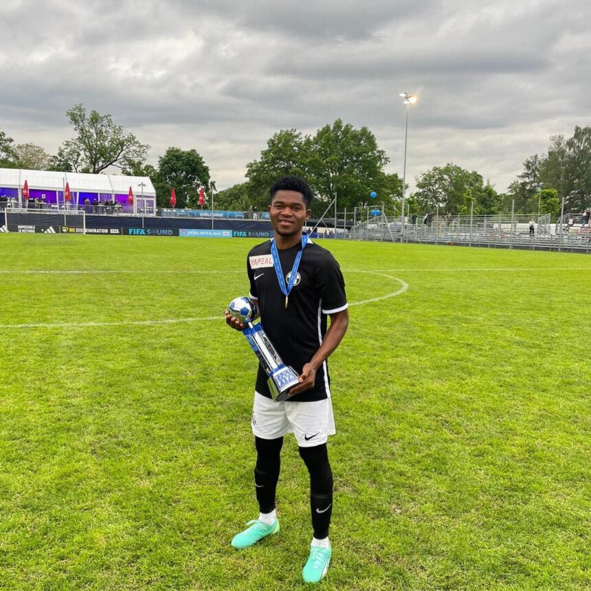 Joseph Banda with the Blue Stars/FIFA Youth Cup trophy in Zurich. (Photo/courtesy)