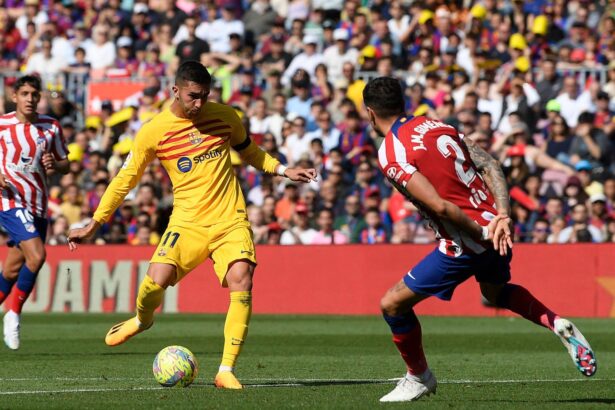 Ferran Torres (L) scores his team's first goal during the Spanish league football match between FC Barcelona and Club Atletico de Madrid at the Camp Nou stadium in Barcelona on April 23, 2023. (Photo by Josep LAGO / AFP) (Photo by JOSEP LAGO/AFP via Getty Images)