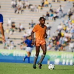 Kalusha Bwalya of Zambia (centre) on the pitch during the Zambia v Italy match during the 1988 Summer Olympics, Gwangju Mudeung Stadium, South Korea, 19th September 1988. Bwalya scored a hat-trick in the game and Zambia went on to beat Italy 4 - 0. (Photo by Bob Thomas Sports Photography via Getty Images)