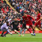 Gabriel Martinelli of Arsenal scores the team's first goal as Alisson Becker of Liverpool fails to make a save during the Premier League match between Liverpool FC and Arsenal FC at Anfield on April 09, 2023 in Liverpool, England. (Photo by Shaun Botterill/Getty Images)