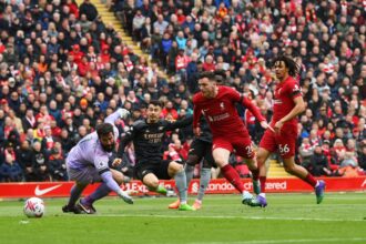 Gabriel Martinelli of Arsenal scores the team's first goal as Alisson Becker of Liverpool fails to make a save during the Premier League match between Liverpool FC and Arsenal FC at Anfield on April 09, 2023 in Liverpool, England. (Photo by Shaun Botterill/Getty Images)