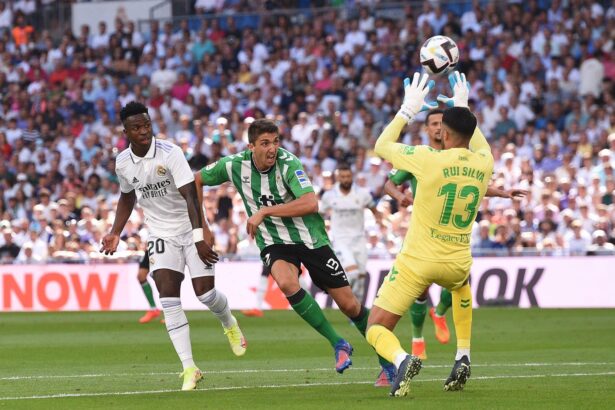 Vinicius Junior of Real Madrid shoots the ball past Rui Silva of Real Betis to score their team's opening goal during the LaLiga Santander match between Real Madrid CF and Real Betis at Estadio Santiago Bernabeu on September 03, 2022 in Madrid, Spain. (Photo by Denis Doyle/Getty Images)