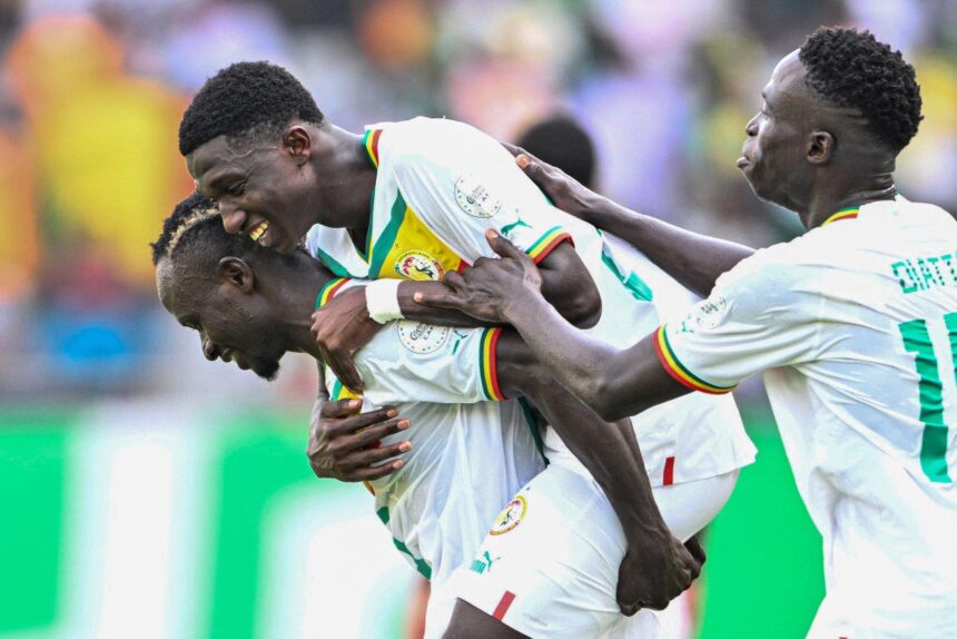 Lamine Camara (C) celebrates with teammates after scoring his team's third goal during the Africa Cup of Nations (CAN) 2024 group C football match between Senegal and Gambia at Stade Charles Konan Banny in Yamoussoukro on January 15, 2024. (Photo by Issouf SANOGO / AFP) (Photo by ISSOUF SANOGO/AFP via Getty Images)