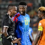 DR Congo's defender #22 Chancel Mbemba (C) speaks with Zambia's midfielder #8 Lubambo Musonda (R) and Ethiopian referee Bamlak Tessema Weyessa (L) during the Africa Cup of Nations (CAN) 2024 group F football match between DR Congo and Zambia at Stade Laurent Pokou in San Pedro on January 17, 2024. (Photo by SIA KAMBOU / AFP)