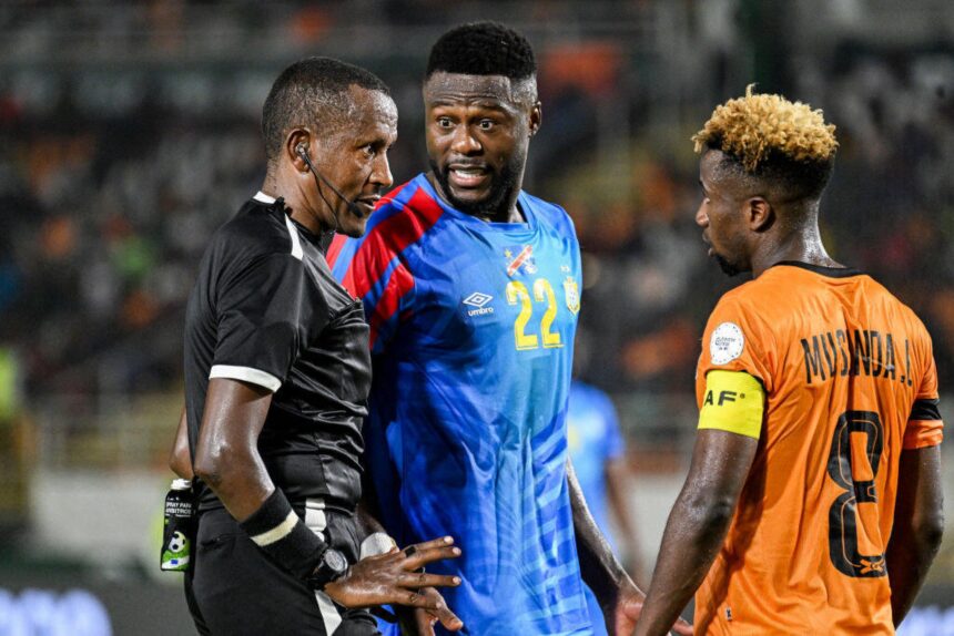 DR Congo's defender #22 Chancel Mbemba (C) speaks with Zambia's midfielder #8 Lubambo Musonda (R) and Ethiopian referee Bamlak Tessema Weyessa (L) during the Africa Cup of Nations (CAN) 2024 group F football match between DR Congo and Zambia at Stade Laurent Pokou in San Pedro on January 17, 2024. (Photo by SIA KAMBOU / AFP)