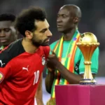 Egypt's forward Mohamed Salah walks past the trophy after losing the 2021 Africa Cup of Nations final match between Senegal and Egypt at Stade d'Olembe in Yaounde on February 6, 2022. (PHOTO / AFP)
