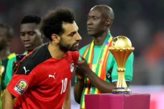 Egypt's forward Mohamed Salah walks past the trophy after losing the 2021 Africa Cup of Nations final match between Senegal and Egypt at Stade d'Olembe in Yaounde on February 6, 2022. (PHOTO / AFP)
