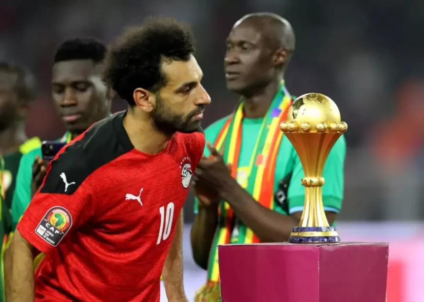 Egypt's forward Mohamed Salah walks past the trophy after losing the 2021 Africa Cup of Nations final match between Senegal and Egypt at Stade d'Olembe in Yaounde on February 6, 2022. (PHOTO / AFP)