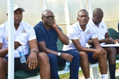 Alex Namazamba (second from left) on the Green Eagles bench during a Zambian Super League match. (Photo via Green Eagles FC Media)