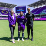Barbra Banda(C), with Orlando Pride Head Coach Seb Hines(R) and General Manager and VP of Soccer Operations Haley Carter(L) at INTER&Co Stadium in Orlando, Florida.