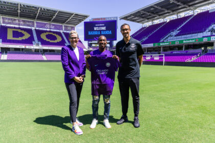 Barbra Banda(C), with Orlando Pride Head Coach Seb Hines(R) and General Manager and VP of Soccer Operations Haley Carter(L) at INTER&Co Stadium in Orlando, Florida.
