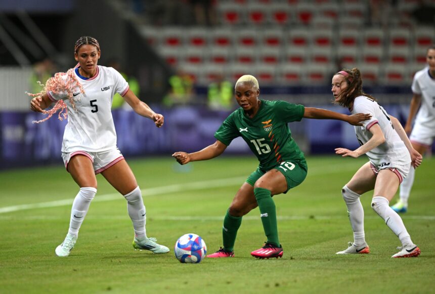NICE, FRANCE - JULY 25: Hellen Chanda #15 of Team Zambia is challenged by Rose Lavelle #16 and