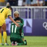 Barbra Banda #11 of Team Zambia is consoled by teammate Martha Tembo #13 and Mary Fowler #11 of Team Australia following a loss in the Women's group B match between Australia and Zambia during the Olympic Games Paris 2024 at Stade de Nice on July 28, 2024 in Nice, France. (Photo by Stuart Franklin - FIFA/FIFA via Getty Images)