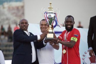 Red Arrows captain Yusuf Saddam receives the trophy from CECAFA President Wallace Karia at the KMC stadium in Tanzania. (Photo via X/@Tanfootball)