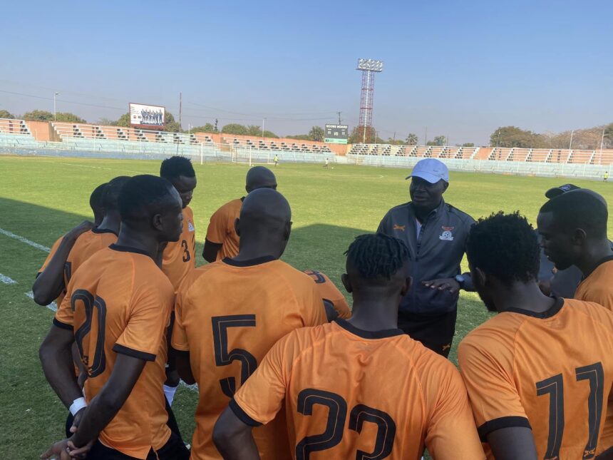 Wedson Nyirenda having a talk with some of the national team players at the Woodlands stadium in Lusaka. (Photo via FAZ media)