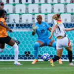 Lea Schueller of Germany (R) attempts a kick for score her goal over Goalkeeper Ngambo Musole of Zambia (C) during the Women's group B match between Zambia and Germany during the Olympic Games Paris 2024 at Stade Geoffroy-Guichard on July 31, 2024 in Saint-Etienne, France. (Photo by Eurasia Sport Images/Getty Images)