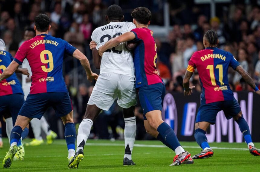 Pau Cubarsi of FC Barcelona (R) fights for the position against Antonio Rudiger of Real Madrid CF (L) during the La Liga EA Sports 2024/25 football match between Real Madrid CF vs FC Barcelona at Estadio Santiago Bernabeu on October 26, 2024 in Madrid, Spain. (Photo by Alberto Gardin/ZUMA Press Wire)