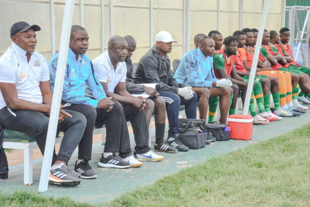 Kebby Hachipuka with members of his technical bench during a super league game. (Photo via Green Eagles FC media)