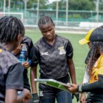 Natasha Nkaka and her teammates receiving instructions from head coach Carol Kanyemba during training in Lusaka. (Photo via FAZ media)