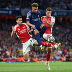 LONDON, ENGLAND - APRIL 29: Desire Doue of Paris Saint-Germain is challenged by Mikel Merino and Jakub Kiwior of Arsenal during the UEFA Champions League 2024/25 Semi Final First Leg match between Arsenal FC and Paris Saint-Germain at Emirates Stadium on April 29, 2025 in London, England. (Photo by Justin Setterfield/Getty Images)