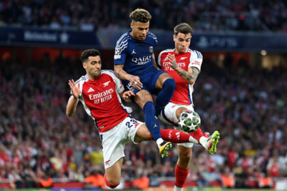 LONDON, ENGLAND - APRIL 29: Desire Doue of Paris Saint-Germain is challenged by Mikel Merino and Jakub Kiwior of Arsenal during the UEFA Champions League 2024/25 Semi Final First Leg match between Arsenal FC and Paris Saint-Germain at Emirates Stadium on April 29, 2025 in London, England. (Photo by Justin Setterfield/Getty Images)