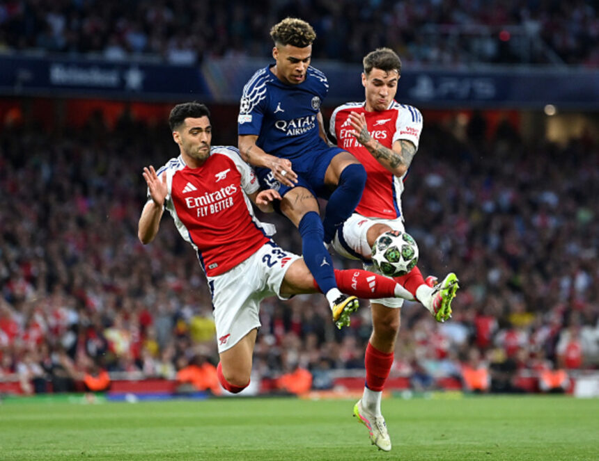 LONDON, ENGLAND - APRIL 29: Desire Doue of Paris Saint-Germain is challenged by Mikel Merino and Jakub Kiwior of Arsenal during the UEFA Champions League 2024/25 Semi Final First Leg match between Arsenal FC and Paris Saint-Germain at Emirates Stadium on April 29, 2025 in London, England. (Photo by Justin Setterfield/Getty Images)