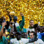 Senegal's team members celebrate with the trophy after winning the Africa Cup of Nations (CAN) final football match against Morocco at the Prince Moulay Abdellah Stadium in Rabat on January 18, 2026. (Photo by Abdel Majid BZIOUAT / AFP via Getty Images)