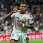Real Madrid's French forward #10 Kylian Mbappe celebrates scoring a hat-trick and his team's fourth goalduring the Spanish league football match between Real Madrid CF and Real Sociedad at Santiago Bernabeu Stadium in Madrid on August 26, 2026. (Photo by Thomas COEX / AFP via Getty Images)