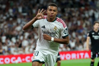 Real Madrid's French forward #10 Kylian Mbappe celebrates scoring a hat-trick and his team's fourth goalduring the Spanish league football match between Real Madrid CF and Real Sociedad at Santiago Bernabeu Stadium in Madrid on August 26, 2026. (Photo by Thomas COEX / AFP via Getty Images)