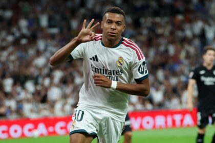 Real Madrid's French forward #10 Kylian Mbappe celebrates scoring a hat-trick and his team's fourth goalduring the Spanish league football match between Real Madrid CF and Real Sociedad at Santiago Bernabeu Stadium in Madrid on August 26, 2026. (Photo by Thomas COEX / AFP via Getty Images)