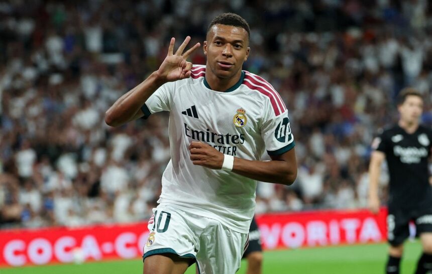 Real Madrid's French forward #10 Kylian Mbappe celebrates scoring a hat-trick and his team's fourth goalduring the Spanish league football match between Real Madrid CF and Real Sociedad at Santiago Bernabeu Stadium in Madrid on August 26, 2026. (Photo by Thomas COEX / AFP via Getty Images)